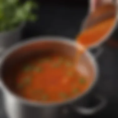 A close-up of the Barbie Q sauce simmering in a pot with aromatic herbs