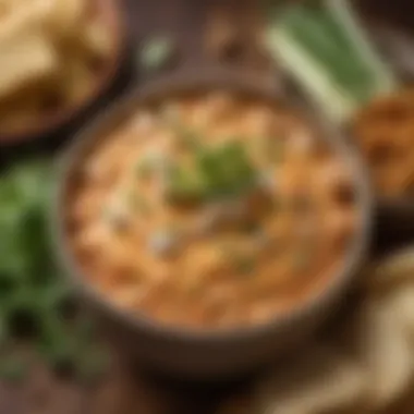 A creamy buffalo chicken dip in a rustic bowl garnished with fresh herbs