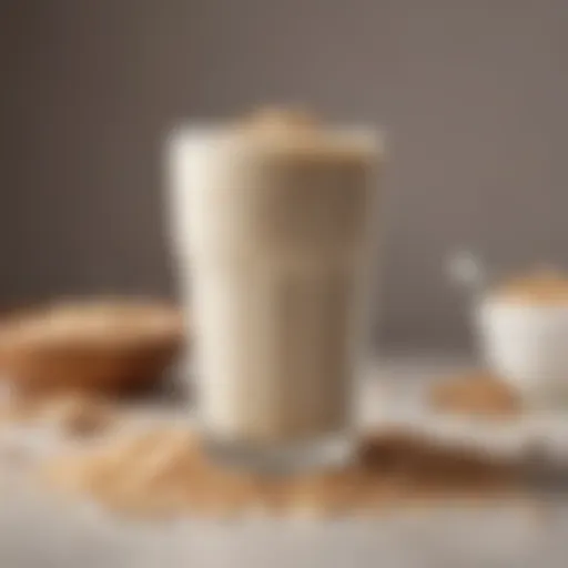 Close-up of creamy oat milk in a glass with oats scattered around