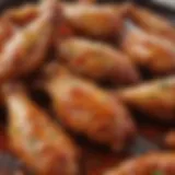 Close-up of perfectly glazed chicken wings with a vibrant sauce