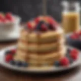 A stack of fluffy almond flour pancakes topped with fresh berries and a drizzle of maple syrup