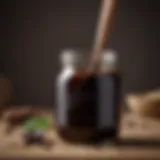 A close-up view of blackstrap molasses in a glass jar with a wooden spoon.