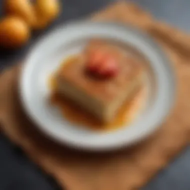 Plated Slice of Sweet Matzo Kugel A slice of sweet matzo kugel served on a decorative plate with a fruit garnish