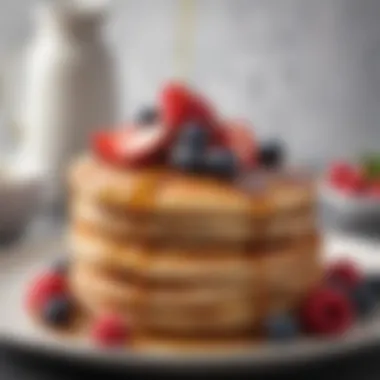 A stack of fluffy pancakes drizzled with maple syrup and fresh berries