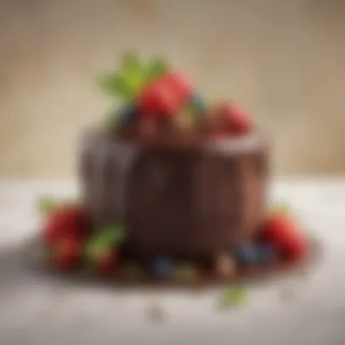 An elegant chocolate cake adorned with fresh berries and mint leaves.