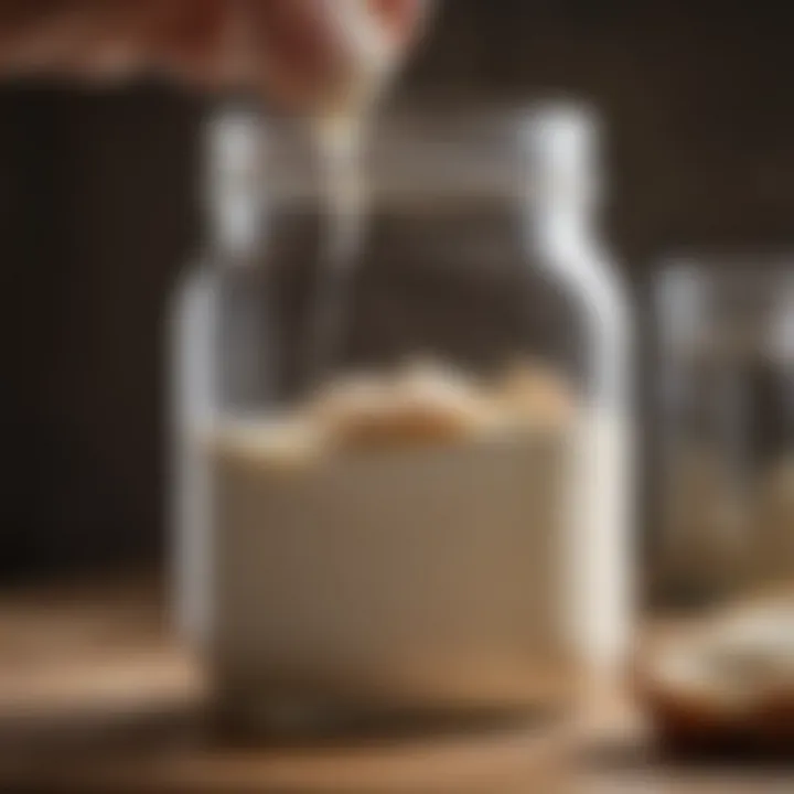 A close-up view of a sourdough starter jar being inspected for consistency and bubbles.