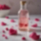 A delicate bottle of rose water surrounded by fresh rose petals