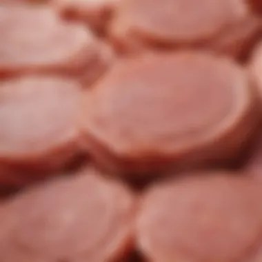 A close-up of price tags on spiral cut hams, illustrating price variations.