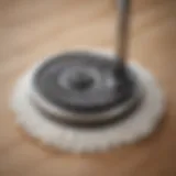 Close-up view of a swirl mop with a foot pedal mechanism