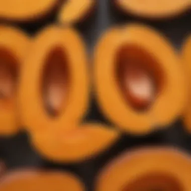 A close-up of a sweet potato cut in half, revealing its rich orange flesh and intricate patterns