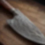 Close-up view of a handcrafted Damascus chef knife showcasing intricate patterns.
