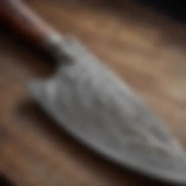 Close-up view of a handcrafted Damascus chef knife showcasing intricate patterns.