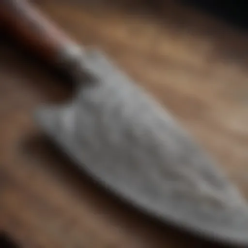Close-up view of a handcrafted Damascus chef knife showcasing intricate patterns.
