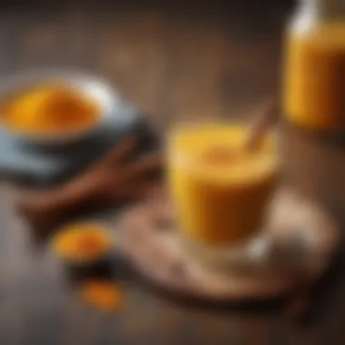 Turmeric powder drink in a clear glass with a sprinkle of cinnamon on top